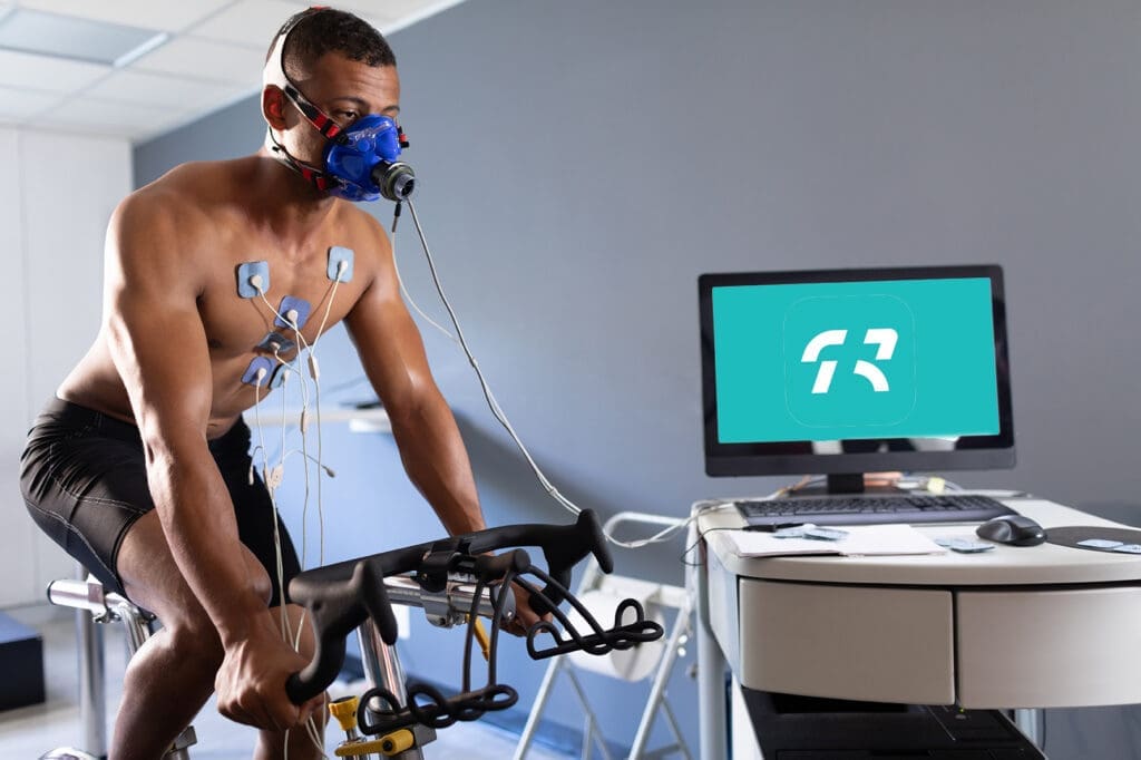 man on cardio bike hooked up to heart monitors